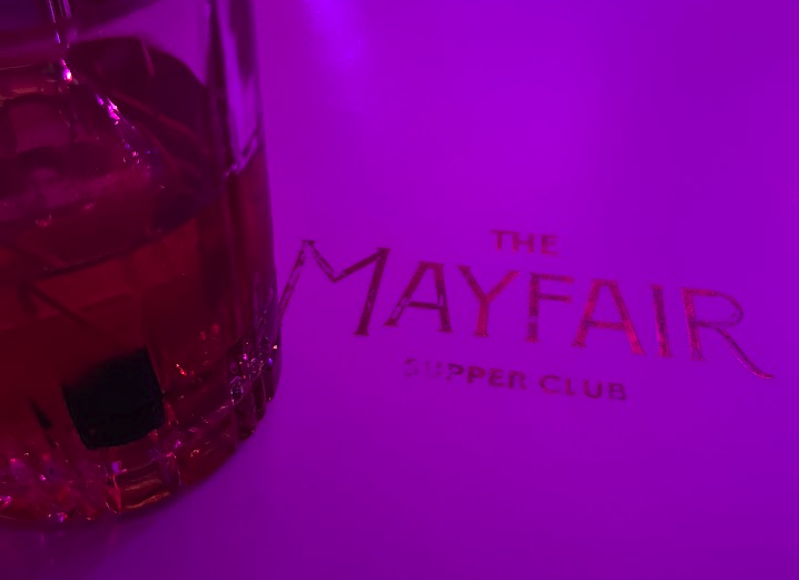 A picture of a drink on a Mayfair Supper Club napkin.