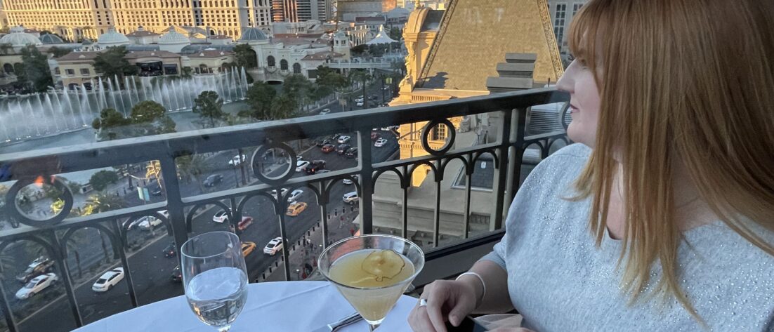 A woman looks at the Las Vegas Strip from the Eiffel Tower Restaurant.