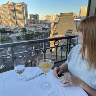 A woman looks at the Las Vegas Strip from the Eiffel Tower Restaurant.